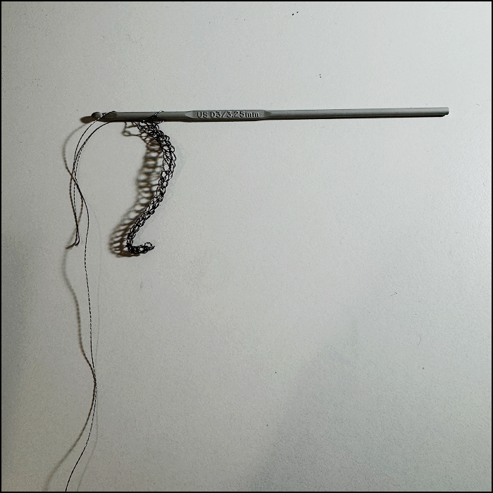 Progress of crocheting the conductive thread, consisting og single stiches