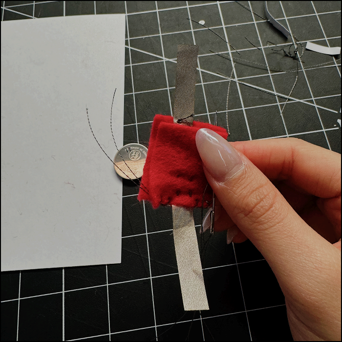 Image shows progress on the battery holder, stiches are uneven as the needle had difficulty piercing through the conductive fabric